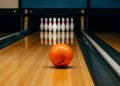 Bowling balls and pins set up on a polished lane, highlighting beginner-friendly bowling setup